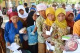 Sejumlah warga antri menerima sembako dari Program Nasional Pemberdayaan Masyarakat Mandiri Perdesaan (PNPM Mandiri Perdesaan) tahun 2015 di Kecamatan Besuki, Situbondo, Jawa Timur, Minggu (20/9). Unit pengelola kegiatan (UPK) PNPM Mandiri Perdesaan menyalurkan 350 paket bantuan sembako ke warga miskin.Antara Jatim/Seno/zk/15.