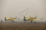 Dua Pesawat Air Tractor AT802F milik Kementerian Lingkungan Hidup dan Kehutanan (KLHK) asal Australia parkir di base ops Landasan Udara (Lanud) Palembang menunggu jarak pandang membaik, Palembang, Sumsel. Senin (28/9). Berdasarkan data dari BMKG jarak pandang di Palembang mengalami penurunan hingga 300m. Operasi pemadaman kebakaran lahan dari udara (water boombing) tidak dapat dilakukan jika jarak pandang dibawah 1500m. ANTARA FOTO/Nova Wahyudi/nz/15
