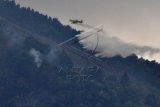 Pesawat jenis Air Tracktor menyiramkan air ketika memadamkan kebakaran di kawasan Taman Nasional Gunung Merbabu, Ampel, Boyolali, Jawa Tengah, Kamis (8/10). Badan Penanggulangan Bencana Daerah (BPBD) Boyolali memadamkan api yang membakar kawasan taman nasional itu dengan bom air menggunakan pesawat jenis Air Tracktor berkapasitas 3000 liter air. ANTARA FOTO/ Aloysius Jarot Nugroho/Spt/15.
