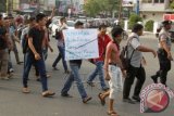 Mahasiswa asal Kabupaten Aceh Singkil, Aceh, membawa poster dan spanduk saat berunjukrasa di Bundaran Simpang Lima, Banda Aceh, Selasa (13/10). Mahasiswa menuntut pemerintah Aceh Singkil menuntaskan konflik sara di daerah itu agar terwujud kerukunan antar umat beragama dan hukum ditegakkan dengan benar. ANTARA FOTO/Ampelsa/ama/15