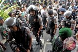 Sejumlah polisi bersenjata memasuki lembaga pemasyarakatan (Lapas) untuk menggeledah ruang tahanan dan narapidana pascabentrok di Lapas Kerobokan, Badung, Bali, Sabtu (19/12). Dalam penggeledahan tersebut, polisi menyita 129 handphone, 2 unit laptop, ekstasi, ganja, pohon ganja, paket sabu-sabu beserta 50 alat hisap, 13 buah senjata tajam, 2 pucuk senjata api beserta 90 butir peluru. FOTO ANTARA/Nyoman Budhiana/i018/2015.