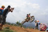 Seorang pembalap melakukan jumping style dalam kejuaraan motocross yang digelar di sirkuit Pantai Prigi, Trenggalek, Jawa Timur, Minggu (20/12). Kejuaraan motocross yang diikuti 198 pembalap lokal dan nasioonal itu digelar dalam rangka mencari bibit-bibit unggul pembalap nasional. Antara Jatim/Foto/Destyan Sujarwoko/zk/15