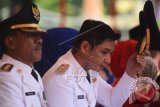 Sigit Purnomo Said alias Pasha Ungu (kanan) melepas topinya usai dilantik sebagai Wakil Walikota Palu, Sulawesi Tengah, Rabu (17/2). Meskipun telah menjadi pejabat publik namun Pasha mengaku tidak akan melepas posisinya sebagai vokalis di Band Ungu. ANTARA FOTO/Basri Marzuki/wdy/16.