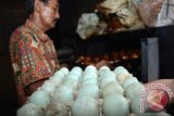Seorang peternak mengukus telur asin untuk proses varian rasa di rumah industri kampung bebek Desa Kebon Sari, Candi, Sidoarjo, Jawa Timur,  Selasa (1/3). Harga telur asin naik dari Rp2.700 per butir menjadi Rp3.100 per butir akibat cuaca buruk beberapa hari terakhir yang mengakibatkan produksi telur bebek menurun dari yang biasanya bebek bisa produksi 1500 telur perhari kini menjadi 500 telur. Antara Jatim/Umarul Faruq/zk/16


