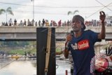 Musisi Reggae asal Jamaika Squidly Cole bernyanyi diatas panggung terapung di Sungai Jangkuk, Ampenan, Mataram, NTB, Sabtu (26/3). Squidly Cole sengaja datang ke Ampenan Lombok untuk ikut mengkampanyekan kepedulian terhadap lingkungan khususnya di sungai dan laut serta sekaligus memperingati Hari Air Sedunia atau 'World Water Day' yang diperingati setiap tanggal 22 Maret. ANTARA FOTO/Ahmad Subaidi/wdy/16.
