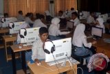 Sejumlah siswa-siswa SMK Negeri 1 Samarinda, Kalimantan Timur, tampak serius mengerjakan soal saat pelaksanaan Ujian Nasional Berbasis Komputer, Senin (4/4).