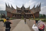 Sejumlah wisatawan memotret Istana Basa Pagaruyung, di Kabupaten Tanah Datar, Sumatera Barat, Jumat (22/4). Komplek Istana Basa Pagaruyung yang dibangun 27 Desember 1976 itu merupakan replika dari istana yang asli dan kini menjadi salah satu tujuan wisata sejarah favorit di Sumbar. ANTARA FOTO/Iggoy el Fitra/wdy/16.