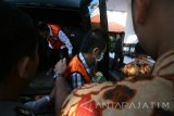 Tersangka persetubuhan anak berinisian SS (tengah) turun dari mobil tahanan dengan pengawalan ketat anggota polisi di Pengadilan Negeri Kota Kediri, Jawa Timur, Kamis (19/5). Tersangka yang diduga telah melakukan hubungan badan terhadap 58 anak tersebut siang nanti akan mengikuti sidang putusan / vonis. Antara jatim/Prasetia Fauzani/zk/16