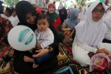 Wali Kota Banda Aceh Illiza Saaduddin Djamal memangku salah seorang dari 600 lebih anak yatim saat menghadiri buka puasa bersama pada peringatan Hari Yatim Sedunia Islam ke-III yang diselenggarakan Pemerintah Kota bersama Rumah Zakat (RZ) di Banda Aceh, Aceh, Senin (20/6). Organisasi Kerja sama Islam (OKI) telah menetapkan 15 Ramadan sebagai Hari Yatim Sedunia Islam dan menjadi momentum untuk peduli dan berbagi. ANTARA FOTO/Irwansyah Putra/foc/16.