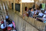 Sejumlah pelajar kelas 1 sampai 6 belajar di ruang kelas SDN Cobbuk Desa Curah Tatal, Arjasa, Situbondo, Jawa Timur, Selasa (26/7). SDN Cobbuk merupakan SDN Filial dari SDN 8 Curah Tatal dengan jumlah murid kelas 1 sampai 6 sebanyak 32 siswa dengan sarana prasarana pendidikan minim, seperti lantai tanah, dinding kayu, siswa menggunakan sandal jepit, buku pelajaran belum standart. Antara Jatim/Seno/zk/16.