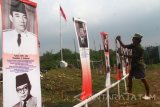 Seorang warga memasang poster presiden dan mantan presiden di sepanjang jalan Mayjen Sungkono, Malang, Jawa Timur, Selasa (16/8). Poster presiden dan mantan presiden tersebut dipasang untuk memeriahkan HUT Kemerdekaan RI  sekaligus bertujuan mengingatkan masyarakat tentang perjalanan sejarah pergantian pemimpin bangsa Indonesia. Antara Jatim/Ari Bowo Sucipto/zk/16.