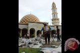 Petugas mengumpulkan sampah koran bekas yang berserakan seusai pelaksanaan salat Iduladha 1437 H di Masjid Raya Alfatah, Ambon, Maluku, Senin (12/9). Sebagian jemaah meninggalkan sampah koran yang dipakai sebagai alas salat, sehingga mengotori halaman masjid. ANTARAFOTO/izaac mulyawan/aww/16.