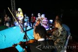 Bojonegoro - Seorang penyanyi dengan iringan grup keroncong menyanyi di atas panggung di tepian Bengawan Solo di Kabupaten Bojonegoro, Jawa Timur, Minggu (25/9). Panggung hiburan keroncong itu merupakan salah satu acara dalam kegiatan 