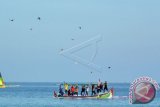 Sejumlah nelayan menerbangkan ayam di tengah laut dalam lomba ayam 'sap-sap' (ayam terbang) di Pantai Pasir Putih, Bungatan, Situbondo, Jawa Timur, Sabtu (10/9). Ayam 'sap-sap' merupakan lomba tradisional masyarakat pesisir Situbondo dengan menerbangkan ayam betina dari atas perahu di tengah laut ke daratan sejauh 200 meter. ANTARA FOTO/Seno/wdy/16.