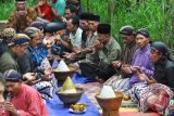 Sejumlah warga berdoa bersama di petilasan Kali Panjang saat ritual Merti Dusun di kawasan lereng Gunung Prahu, Dusun Bakal, Campurejo, Tretep, Temanggung, Jawa Tengah, Jumat (7/10). Warga yang sebagian besar petani tembakau tersebut rutin melakukan ritual tahunan setiap Jumat Kliwon bulan Suro sebagai sarana memanjatkan doa sekaligus sebagai ungkapan syukur kepada Tuhan YME atas kemakmuran dan kesejahteraan warga setempat. ANTARA FOTO/Anis Efizudin/wdy/16.