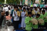 Sejumlah orang terdiri santri, kiai dan Pengurus Cabang NU serta warga nahdliyin melantunkan shalawat banjari diiringi rebana saat peringatan Hari Santri 2016 di Magetan, Jawa Timur, Sabtu (22/10). Ribuan santri bersama warga nahdliyin mengikuti istighatsah dan apel, shalawat banjari dilanjutkan makan bersama beralaskan daun pisang dalam memperingati hari santri 2016. Antara Jatim/Siswowidodo/zk/16