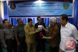 Direktur Komersil, Pengembangan Bisnis dan TI Perum LKBN Antara Hempi N Prajudi (kedua kanan) bersama Kabiro Perum LKBN Antara Sumut Simon Pramono (kanan) memberikan cinderamata kepada Kepala Dinas Kominfo Sumut Muhammad Fitriyus (ketiga kiri) pada pertemuan Badan Koordinasi Humas (Bakohumas) di Medan, Sumatera Utara, Senin (31/10). Pertemuan Bakohumas yang diikuti pejabat humas daerah tersebut bertujuan untuk penguatan kompetensi humas pemerintah melalui standarisasi profesi yang diharapkan mampu melakukan komunikasi publik secara professional, proporsional, memberikan pencerahan, pemberdayaan, dan edukasi yang sesuai dengan nilai-nilai kebangsaan kepada masyarakat. ANTARA SUMUT/Septianda Perdana/16