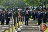 Presiden Joko Widodo (tengah) didampingi Wapres Jusuf Kalla (kedua kanan) dan Pangdam Jaya Mayjen TNI Teddy Lhaksmana (kanan) memanjatkan doa untuk arwah para pahlawan nasional saat tabur bunga usai Upacara Ziarah Nasional di Taman Makam Pahlawan Nasional Utama Kalibata, Jakarta, Kamis (10/11). Upacara tersebut dalam rangka memperingati Hari Pahlawan 10 November. ANTARA FOTO/Widodo S. Jusuf/wdy/16.