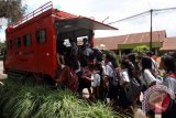 Sejumlah siswa pengungsi Sinabung menaiki kendaraan milik BNPB untuk di antarkan ke sekolah mereka dari tempat pengungsian GBKP Kabanjahe, Sumatera Utara, Kamis (10/11). Sedikitnya 9.317 warga mengungsi akibat erupsi Gunung Sinabung yang tersebar di sembilan lokasi pengungsian. ANTARA SUMUT/Septianda Perdana/16