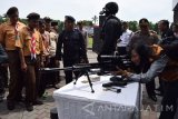 Pengunjung mengamati alat khusus (Alsus) Satbrimob Polda Jatim dan Polres Jombang yang dipamerkan di Alun-alun Jombang, Jawa Timur, Kamis (22/12). Pameran Alsus tersebut bertujuan untuk lebih mengenalkan kepada masyarakat alat persenjataan Polisi serta memberikan jaminan rasa aman kepada masyarakat. Antara Jatim/Syaiful Arif/zk/16