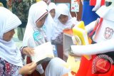 Siswa SD membaca buku di stand Kota Bogor saat pameran dan peluncuran Gerakan Literasi Sekolah (GLS) West Java Leader's Reading Challenge (WJLRC) di Gedung Pusdai, jalan Diponegoro, Bandung, Jawa Barat, Senin (19/12). Peluncuran GLS WJLRC yang dicanangkan Dinas Pendidikan Provinsi Jawa Barat yang diikuti 800 peserta guru maupun siswa dari berbagai wilayah di 27 Kota dan Kabupaten di Jawa Barat ini bertujuan untuk menumbuhkan dan meningkatkan budaya membaca sejak dini. (ANTARA FOTO/Arif Firmansyah/16).