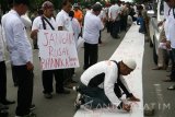 Anggota dari sejumlah organisasi kemasyarakatan menandatangani kain putih saat mengikuti apel kebangsaan di area Simpang Lima Gumul, Kediri, Jawa Timur, Sabtu (4/2). Kegiatan yang dihadiri oleh ribuan orang tersebut sebagai upaya konsulidasi dalam menjaga keutuhan Negara Kesatuan Republik Indonesia (NKRI) dari sejumlah embrio ideologi yang bertentangan dengan Pancasila. Antara Jatim/Prasetia Fauzani/zk/17