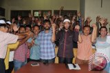 Calon Gubernur dan Calon Wakil Gubernur Aceh nomor urut 5 , Muzakir Manaf (keempat kanan) dan T A Khaliq (ketiga kanan) bersama tim suksesnya mengangkat tangan seusai memberikan keterangan di kantor pemenangan Partai Aceh, Banda Aceh, Kamis (15/2). Pasangan tersebut mengklaim menang pada pilkada serentak berdasarkan hitung cepat dengan perolehan suara 41 persen. (ANTARA FOTO/Ampelsa)