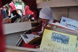 Seorang siswa sekolah dasar membaca buku di perpustakaan bergerak di Balai Kota Surabaya, Jawa Timur, Minggu (12/3). Pemerintah Kota surabaya bekerja sama dengan Gramedia menggelar Karnaval Festival Pustaka Bergerak Surabaya 2017 untuk meningkatkan minat baca masyarakat melalui kegiatan yang menarik. (Antara Jatim/Naufal Ammar/SHP/17)