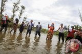 Anggota Sanggar Clemot membaca puisi secara serentak di persawahan Desa Kenep, Sukoharjo, Jawa Tengah, Senin (20/3). Pembacaan puisi dengan tema alam dan pedesaan tersebut untuk menampilkan potensi kreatif warga Desa Kenep sebagai salah satu desa wisata kreatif alternatif. ANTARA FOTO/Maulana Surya/wdy/17.