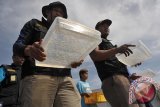 Petugas Balai Karantina Ikan Pengendalian Mutu Denpasar, membawa wadah berisi benih lobster mutiara hasil sitaan, saat pelepasliaran di Pantai Ketewel, Gianyar, Sabtu (1/4). Sebanyak 20.650 ekor benih lobster mutiara senilai Rp2,5 miliar lebih, dilepaskan ke laut setelah berhasil disita dari upaya penyelundupan ke Vietnam melalui Bandara Ngurah Rai. ANTARA FOTO/Nyoman Budhiana/i018/2017.