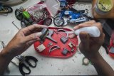 Perajin menyelesaikan kerajinan miniatur motor kuno di Kemlaten, Surabaya, Jawa Timur, Rabu (12/4). Kerajinan yang terbuat dari aluminium tersebut dijual seharga Rp300 ribu- Rp400 ribu tergantung tingkat kesulitannya. Antara Jatim/Naufal Ammar/zk/17.
