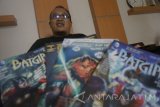 Komikus Ardian Syaf dengan latar depan buku gambar animasi bercerita produksi perusahaan komik internasional Marvel Cimics dan DC Comics di Desa Tenggur, Tulungagung, Jawa Timur, Kamis (13/4). Ardian Syaf mengaku tidak menyangka keisengannya menyisipkan kode 'QS 5:51' dan '212' dalam edisi komik internasional X-Man Gold #1 yang merujuk pada simbol surat Al-Maidah ayat 51  serta aksi damai 212 pada 2 Desember 2016 di Jakarta itu berujung kontroversi yang mengakhiri kariernya di perusahaan komik internasional Marvel dan DC, Amerika Serikat. Antara Jatim/Destyan Sujarwoko/zk/17 