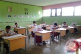 Sejumlah siswa kelas enam dari empat Sekolah Dasar Negeri di Kecamatan Murung Pudak, Kabupaten Tabalong mengikuti ujian sekolah. Para siswa ini terpaksa digabungkan di SD Negeri Masukau Luar karena jumlah siswa di empat sekolah ini sedikit.Foto Antaranews.Kalsel/herlina lasmianti