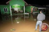 Warga melihat air banjir yang mulai surut di Desa Lomaya, Kecamatan Bulango Utara, Kabupaten Bone Bolango, Gorontalo, Sabtu (3/6) dini hari. Sebanyak 1.540 warga Bulango Utara terdampak banjir akibat curah hujan tinggi yang melanda daerah tersebut pada Jumat (2/6). (ANTARA FOTO/Adiwinata Solihin)
