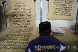  Seorang warga binaan bernama Ahmad Yani menulis mushaf (lembaran) Alquran raksasa di Lapas Klas IIB Blitar, Jawa Timur, Selasa (13/6). Kitab suci Alquran yang memiliki ukuran halaman 90 x 120 centimeter dengan tulisan tangan tersebut, ditargetkan rampung pada lima bulan mendatang. Antara Jatim/Irfan Anshori/zk/17 