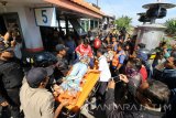 Petugas menandu korban tertabrak kereta api untuk dilakukan perawatan di RSUD dr Soetomo, di perlintasan kereta api Jalan Ambengan Surabaya, Jawa Timur, Senin (19/6). Korban berinisial R P dengan mengendarai sepeda motor bernopol L 5751 AJ tersebut tertabrak KA Dhoho akibat nekad menerobos perlintasan kereta api yang sudah tertutup. Antara Jatim/Didik Suhartono/zk/17