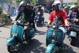 sejumlah anak yatim menaiki scooter modifikasi melintasi rute yang telah ditentukan saat acara bertajuk 'Kediri Scooter Festival' di Gor Jayabaya Kota Kediri, Jawa Timur, Minggu (30/7). Kegiatan berkumpulnya anggota klub scooter Vespa tersebut dihadiri oleh sedikitnya 2.500 orang pecinta vespa dari sejumlah daerah se-Indonesia dan dimeriahkan dengan touring bersama, kontes modifikasi, dan bakti sosial. Antara JAtim/Prasetia Fauzani/zk/17