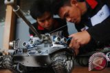 Mahasiswa Fakultas Teknik Elektro Telkom University Ringga Andira (kiri) dan Swido Gari Tidargo (kanan) melakukan perakitan robot pengintai 'Eirdroid Spy', di Jatinangor, Sumedang, Jawa Barat, Rabu (2/8). Mahasiswa tersebut membuat robot 'Eirdroid Spy' bersistem pengendali HP Android untuk dikembangkan menjadi pengintaian jarak jauh via live streaming dan bahan edukasi bagi mahasiswa. Antara Foto/Fahrul Jayadiputra/i018/2017.