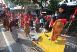 Sejumlah perempuan belajar tata cara mengenakan kain batik saat acara Gelar Berkain Nuasantara 2017 di Surabaya, Jawa Timur, Minggu (13/8). Kegiatan yang digagas oleh komunitas Bangga Berkain Nusantara tersebut diikuti oleh 200 perempuan guna melestarikan kain batik dan tata cara pemakainnya sebagai khazanah kebudayaan Indonesia. Antara Jatim/Moch Asim/zk/17