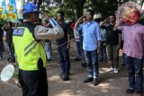 Kanit Pendidikan dan Rekayasa Satlantas Polres Jakpus AKP Antoni Wijaya (kiri) saat memberikan pelatihan kepada =ak Ogah= atau calon Sukarelawan Pengatur Lalu Lintas (supeltas) di Lapangan Banteng, Jakarta. Satlantas Jakarta Pusat merekrut 48 Pak Ogah dari empat kecamatan yakni Kecamatan Tanah Abang, Kemayoran, Gambir dan Cempaka Putih, untuk membantu kepolisian dalam mengatur lalu lintas. (ANTARA FOTO/Galih Pradipta/Dok).