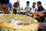 Sejumlah warga Tionghoa menyusun uang kertas mainan yang akan dibakar, saat melaksanakan sembahyang kubur di Komplek Pemakaman Yayasan Bhakti Suci, Sungai Raya, Kabupaten Kubu Raya, Kalbar, Minggu (3/9). Sembahyang kubur yang dilakukan oleh masyarakat Tionghoa penganut agama Budha, Taoisme dan Kong Hu Cu tersebut, merupakan perwujudan tanda bakti kepada leluhur serta orang tua yang wajib dilaksanakan dua kali dalam setahun. ANTARA FOTO/Jessica Helena Wuysang/17 


