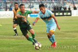 Pemain PS TNI, Roduane Zerzouri (kiri) berusaha mengamankan bola dari jangkauan pemain Persela Eka Ramdani (kanan) dalam pertandingan pekan ke-25 Liga 1 di Stadion Surajaya Lamongan, Jawa Timur, Jumat (22/9). Persela berhasil mengalahkan PS TNI dengan skor tipis 1-0. Antara Jatim/Syaiful Arif/mas/17