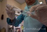 Petugas memasukkan pelarut vaksin MR (measles and rubella) ke dalam jarum suntik saat digelarnya monitoring pelaksanaan imunisasi campak dan rubela di Puskesmas Beji, Tulungagung, Jawa Timur, Kamis (28/9). Menjelang berakhirnya program imunisasi MR pada 30 September 2017, jumlah anak usia 9 bulan hingga 15 tahun di 38 kabupaten/kota se-Jatim yang belum terimunisasi MR hingga 26 September tercatat mencapai sekitar 120 ribu anak dari total target , namun lima kabupaten di antaranya belum memenuhi target sasaran,  Kabupaten Lumajang (77 persen), Sumenep (89 persen), Bangkalan (89 persen), Pamekasan (90 persen) dan Kota Batu (92 persen). Antara Jatim/Destyan Sujarwoko/mas/17.