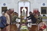 Presiden Joko Widodo (ketiga kanan) didampingi Menko Perekonomian Darmin Nasution (kedua kanan), Seskab Pramono Anung (kanan) menerima Laporan Ikhtisar Hasil Pemeriksaan Semester (IHPS) I Tahun 2017 dari Ketua Badan Pemeriksa Keuangan (BPK) Moermahadi Soerja Djanegara (keempat kiri) disaksikan sejumlah anggota BPK, di Istana Merdeka, Jakarta, Selasa (10/10). Dalam IHPS I Tahun 2017, BPK melaporkan telah menyelamatkan keuangan negara senilai Rp13,70 triliun yang berasal dari penyerahan aset atau penyerahan kas negara, koreksi subsidi, dan koreksi 'cost recovery'. ANTARA FOTO/Puspa Perwitasari/wdy/17
