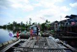 Tiga anak bermain di atas lanting di kawasan Taman Nasional Danau Sentarum (TNDS) di pemukiman Kampung Semangit, Desa Nanga Leboyan, Kecamatan Selimbau, Kabupaten Kapuas Hulu, Kalbar, Jumat (27/10). Pemukiman Kampung Semangit yang berada di atas air dan dihuni hanya 92 Kepala Keluarga (KK) tersebut, menggantungkan hidupnya dari hasil mencari ikan di TNDS. ANTARA FOTO/Hs Putra Pasaribu/jhw/17