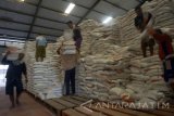 Pekerja kuli angkut memikul karung berisi beras di salah satu gudang milik Perum Bulog Subdivre Tulungagung di Tulungagung, Jawa Timur, Rabu (8/11). Tingginya harga beras di pasaran yang mencapai Rp5.100 per kilogram, jauh di atas ketetapan Harga Pokok Pembelian (HPP) pemerintah Rp4.070 per kilogram menyebabkan Bulog setempat kesulitan memenuhi target serapan sebesar 58 ribu ton selama kurun 2017, mengingat hingga awal November ini baru tercapai 47 persen. Antara Jatim/Destyan Sujarwoko/mas/17.