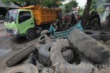 Petugas Satpol PP Kota Surabaya mengangkut ban bekas milik pedagang kaki lima yang berserakan di pinggir jalan di kawasan Kemayoran Baru, Surabaya, Jawa Timur, Rabu (22/11). Penertiban sejumlah PKL penjual ban bekas itu bertujuan untuk mengembalikan fungsi trotoar dan jalan. Antara Jatim/Didik Suhartono/mas/17.