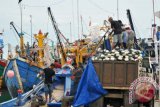 Nelayan memindahkan pukat dari kapal ke truk saat tidak melaut di pelabuhan perikanan Lampulo, Banda Aceh, Aceh, Selasa (5/12). Nelayan setempat tidak melaut akibat terdampak cuaca ekstrem yang memicu gelombang tinggi disertai angin kencang sejak sepekan terakhir yang melanda perairan Aceh. (ANTARA FOTO/Ampelsa/kye/17)
