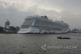  Perahu nelayan melintas di samping kapal pesiar Genting Dream yang bersandar di Dermaga Jamrud Utara, Pelabuhan Tanjung Perak, Surabaya, Jawa Timur, Selasa (9/1). Kapal pesiar yang mengangkut sekitar 4.300 wisatawan asing tersebut mengunjungi sejumlah tempat wisata di Kota Surabaya. Antara Jatim/Moch Asim/zk/17 