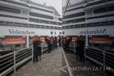 Pengunjung berfoto dengan latar belakang kapal pesiar MS Volendam saat berlabuh di Dermaga Jamrud Utara, Pelabuhan Tanjung Perak, Surabaya, Jawa  Timur, Minggu (7/1). Kapal pesiar yang mengangkut sekitar 1.300 wisatawan mancanegara tersebut akan berkunjung ke sejumlah tempat wisata di Kota Surabaya. Antara jatim/Moch Asim/zk/18